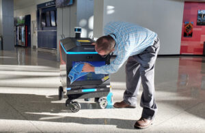 field service agent works on a mobile robot, as Roboworx is offering